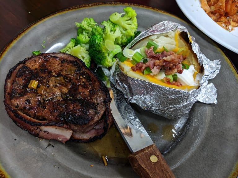 Steak with a fully loaded baked potato